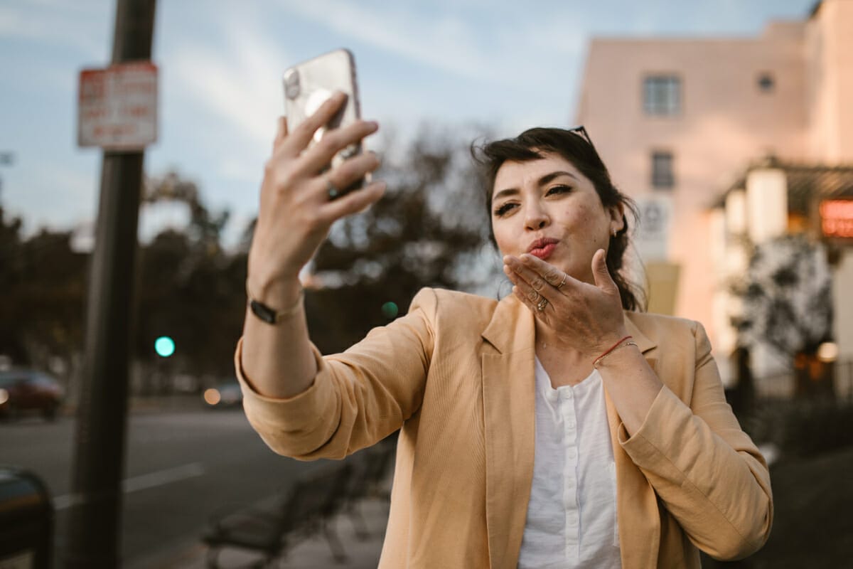 a woman giving a kiss to her long distance partner, ldr, long distance relationship