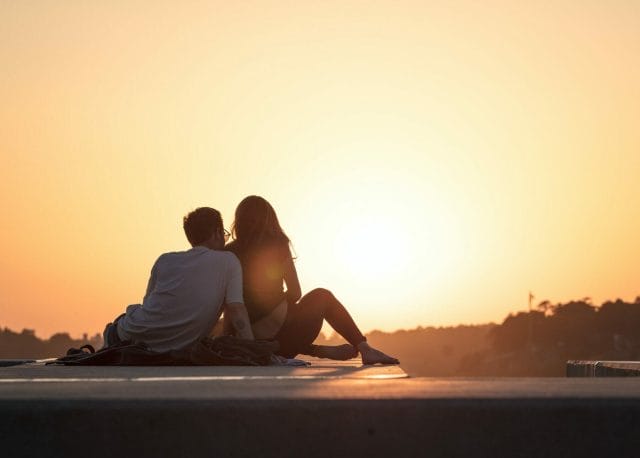 a couple chatting while looking at the sunset together | How Do You Assess The Present State of Your Relationship