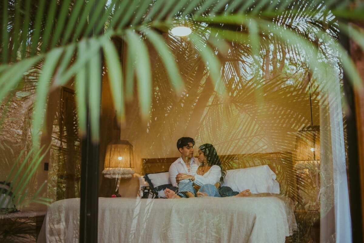 a couple sitting on the bed