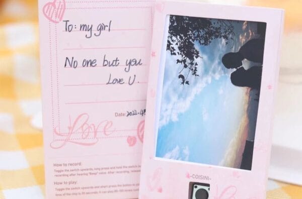 A pink Photo Voice Music Recorder Card photo frame with a heart on it.