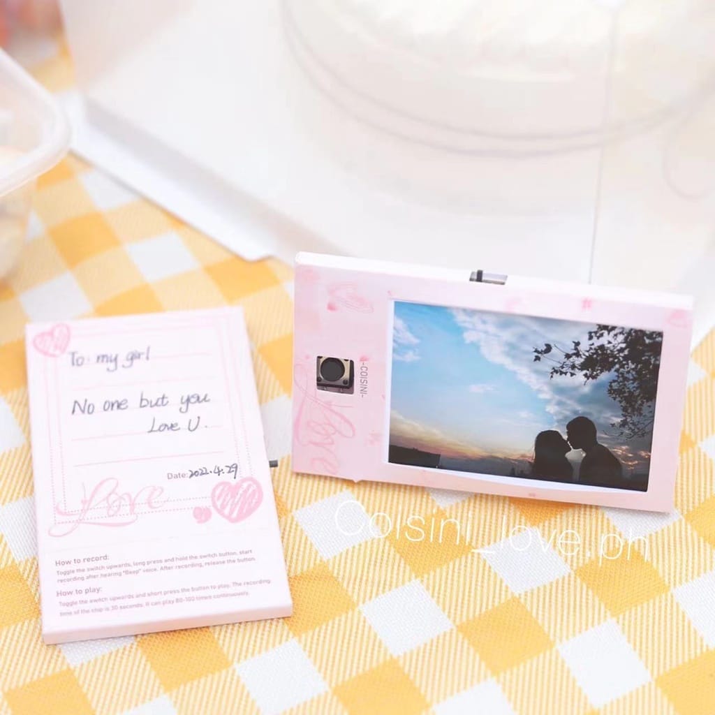 A pink camera and a Photo Voice Music Recorder Card on a table.