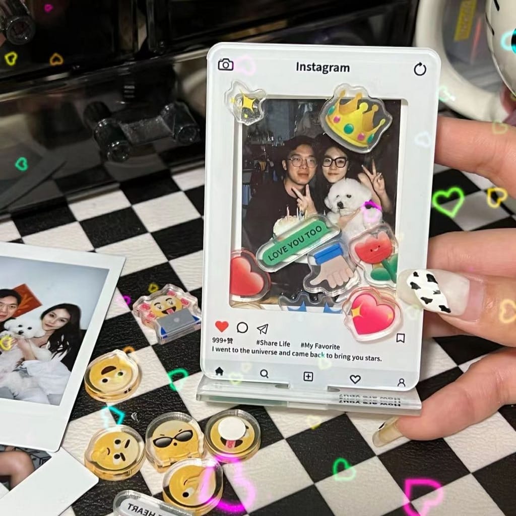 A person holding an Ohaya Emoji Shaking Happy Photo Frame with stickers on it.