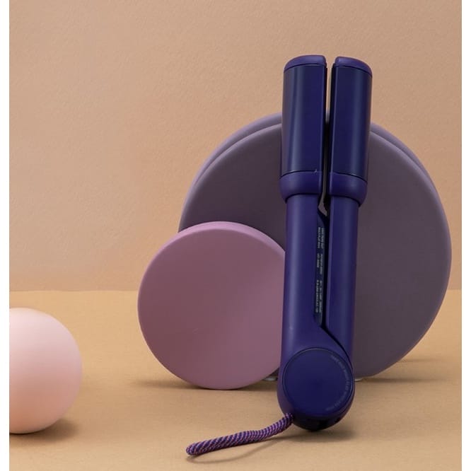 A purple UNIX Mini Wireless Iron Collection next to a pink and purple ball.