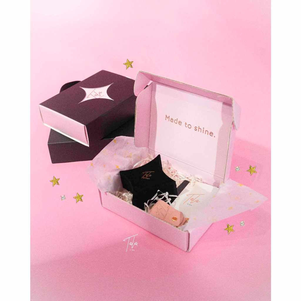 A pink Tala by Kyla My Universe Fidget Ring with a star and a black box.