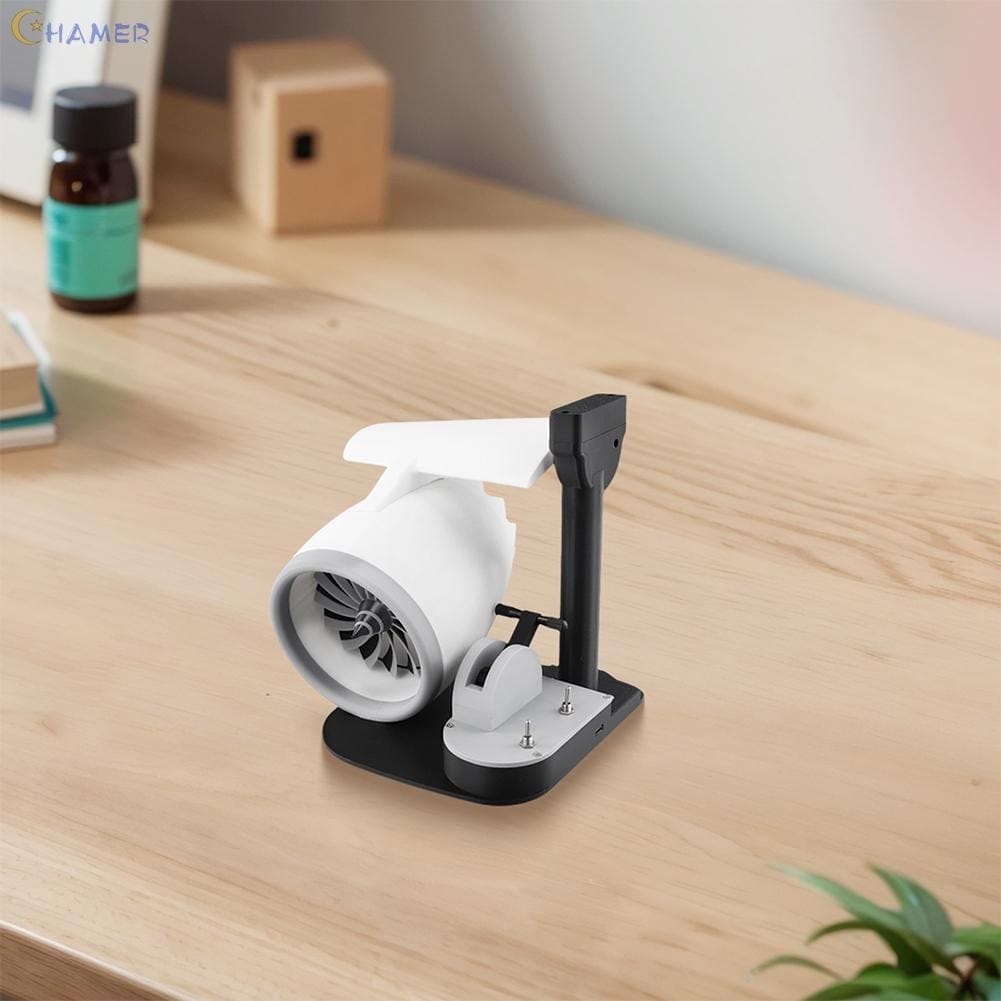 A compact Turbo Jet Fan and Humidifier Engine, featuring a white body on a black stand, is positioned on a wooden desk.